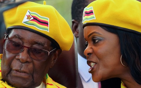 Grace Mugabe talks to the President during rally