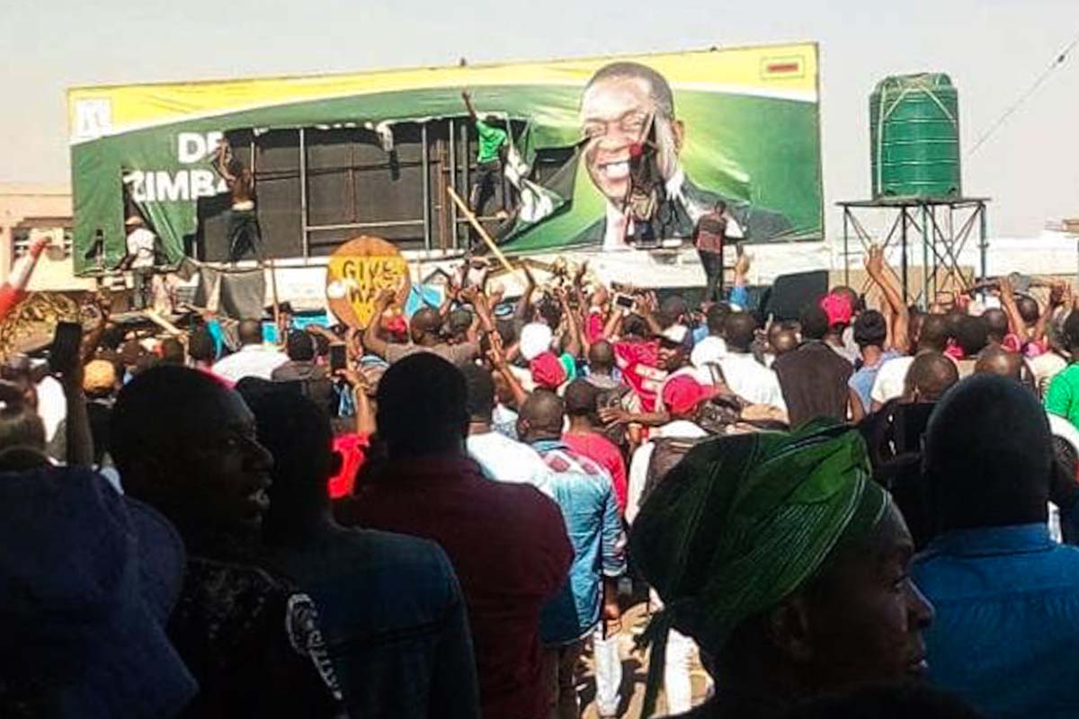 Election poster being ripped up as marchers pass by in Zimbabwe