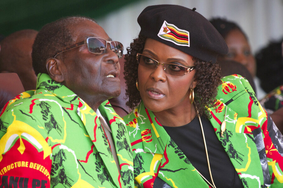A weary Robert Mugabe listens to Grace his wife at a rally