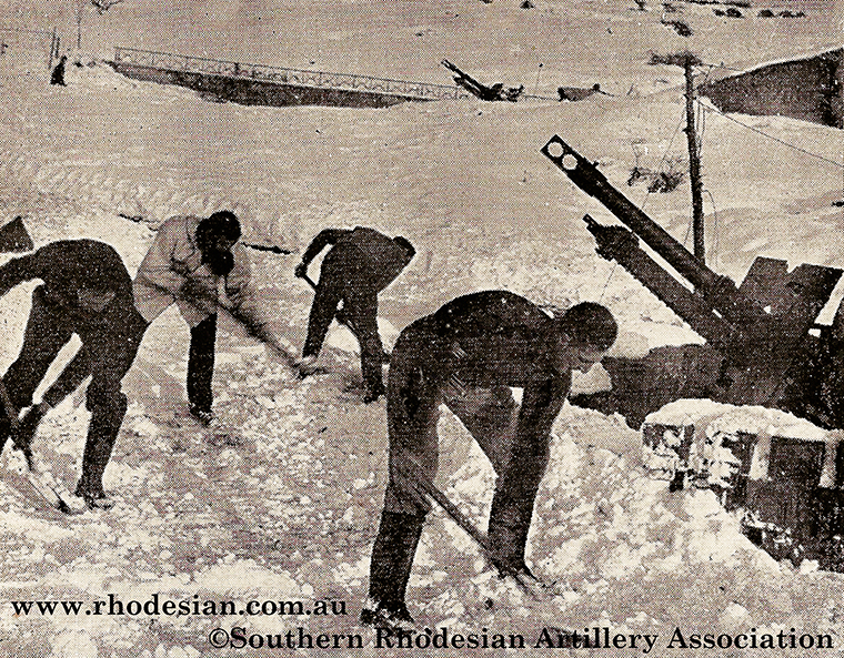 17th Rhodesian Battery artillerymen shovelling snow in Italy during World War II